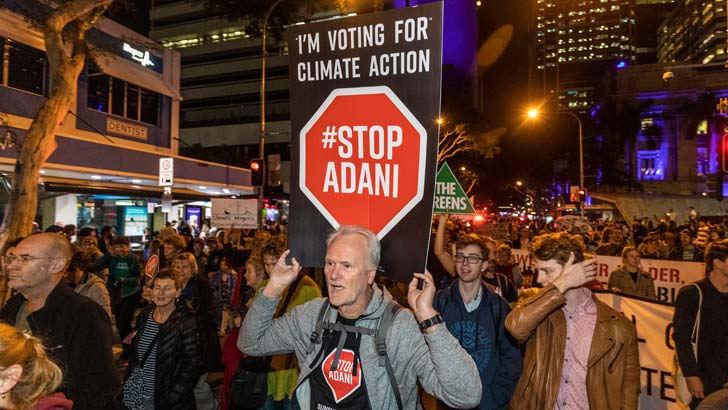 Adani protesters are seen marching through the streets of Brisbane on July 5, 2019 in Brisbane, Australia. The protesters are calling on the Queensland State Government to withdraw its approval of the Adani coal mine in central Queensland. The rally is pa