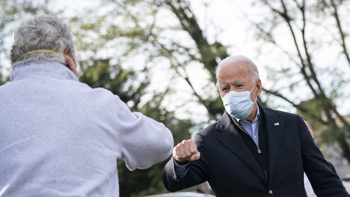 PHILADELPHIA, PA - NOVEMBER 03: Democratic presidential nominee Joe Biden fist bumps a supporter as he makes a stop with local elected officials at Relish Restaurant in Philadelphia, Pennsylvania.