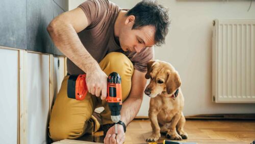 Man doing DIY home construction after shopping with Wesfarmers leading business segment, Bunnings.