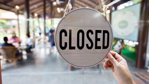 Closing sign in front of cafe, symbolising GROW Super closing its product.