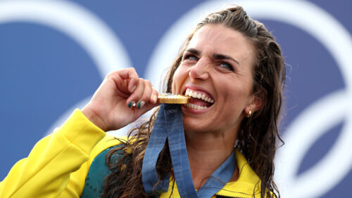Australian gold medallist Jessica Fox bites her medal as she poses on the podium during the Canoe Slalom medal ceremony after the Women's Kayak Single Final at the Olympic Games at Vaires-Sur-Marne Nautical Stadium on July 28, 2024 in Paris, France. Photo
