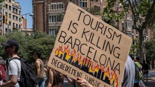 BARCELONA - 2025/06/15: People are seen spraying tourists with water guns and pistols during the demonstration. With more than 20 million tourists expected in 2025, there is increasing contempt toward mass tourism among local citizens