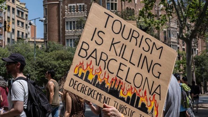 BARCELONA - 2025/06/15: People are seen spraying tourists with water guns and pistols during the demonstration. With more than 20 million tourists expected in 2025, there is increasing contempt toward mass tourism among local citizens