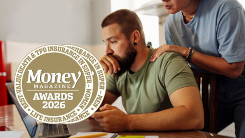 Australian couple checking super and insurance finances at kitchen table