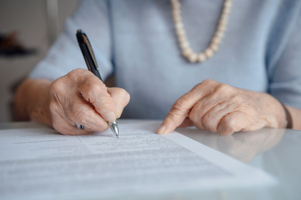 Person reviewing estate planning documents and making financial decisions about a family trust