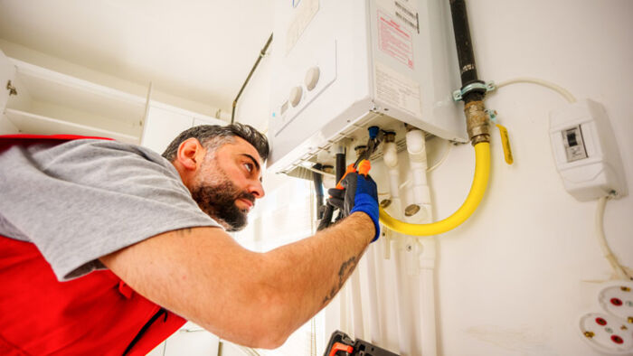 A water heater installed in a residential home. A O Smith shares.