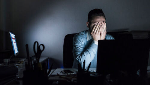 Worker feeling overwhelmed managing multiple tasks and emotional pressure at work