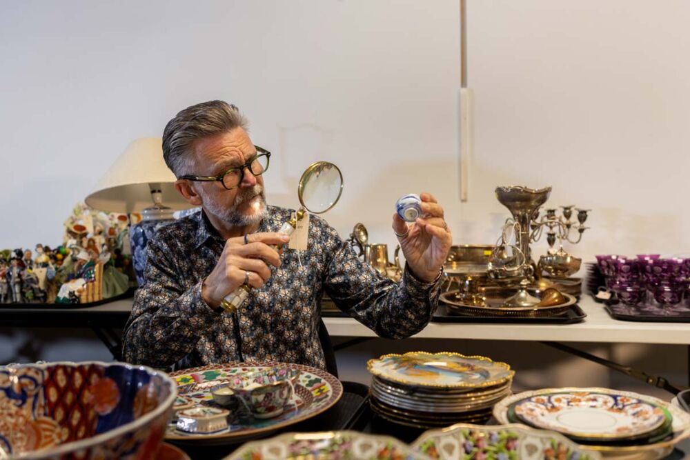 expert examining a collectable item to assess its value