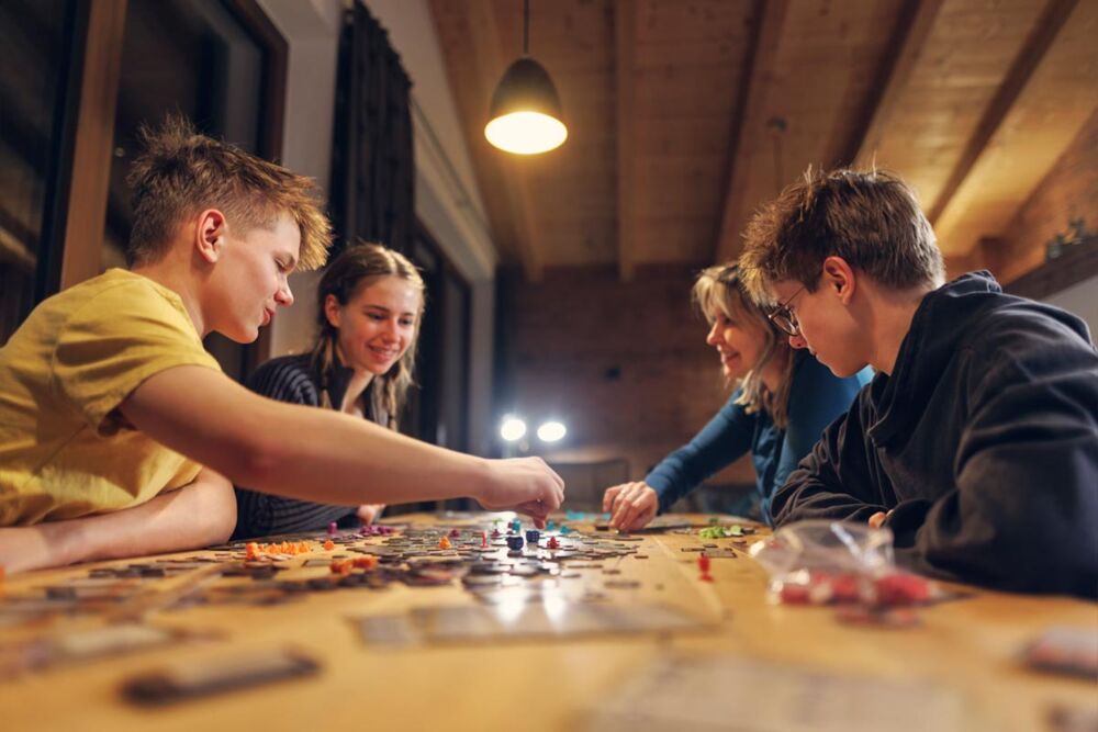 Family playing board games together during the winter school holidays