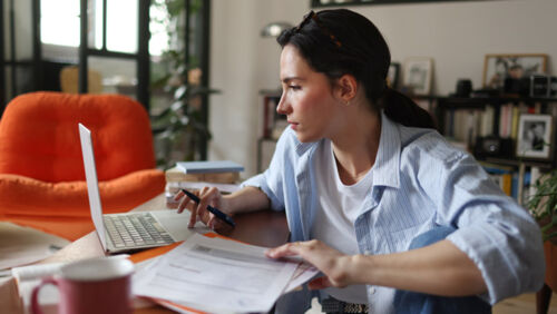 Australian woman reviewing finances as tax cuts, super changes and wage increases begin on July 1 2026