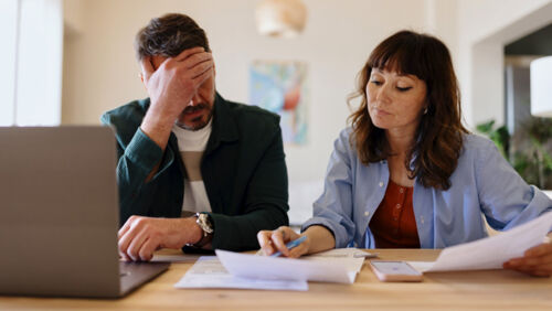 Couple reviewing finances at home after getting married