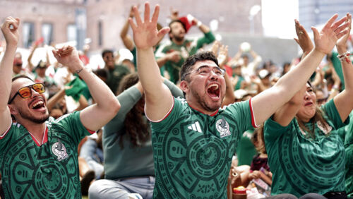 Mexican football fans cheering during a 2026 FIFA World Cup match at Mexico City Stadium