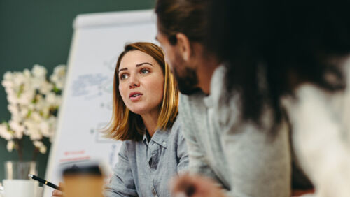 Young Australian workers in discussion about workplace issues and pay