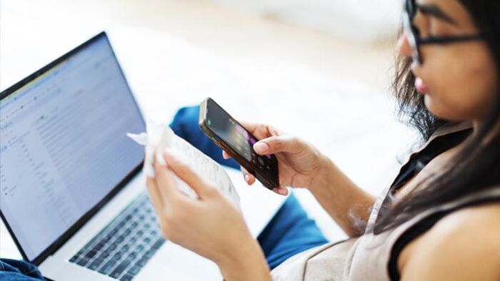 Australian woman reviewing household budget, bills and finances at home at the start of the new financial year