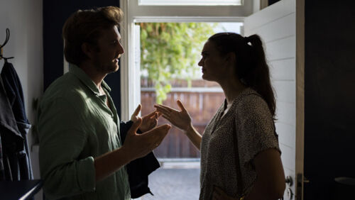 Former partners discussing property ownership after separation.