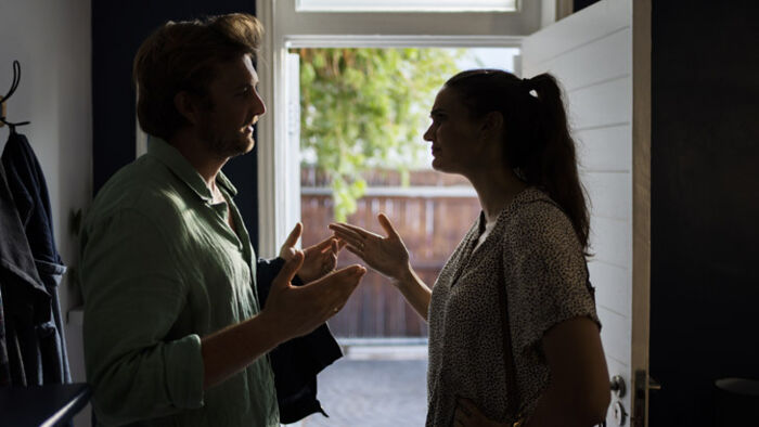 Former partners discussing property ownership after separation.
