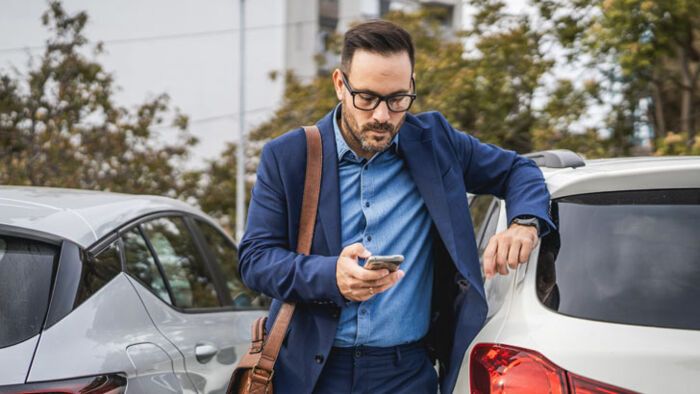 a man reviews car insurance costs on his phone
