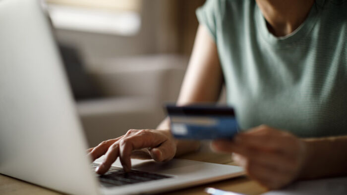 a woman reviews her credit card statement to understand how credit card interest works