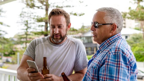 australian man and his father share a beer while discussing inheritance
