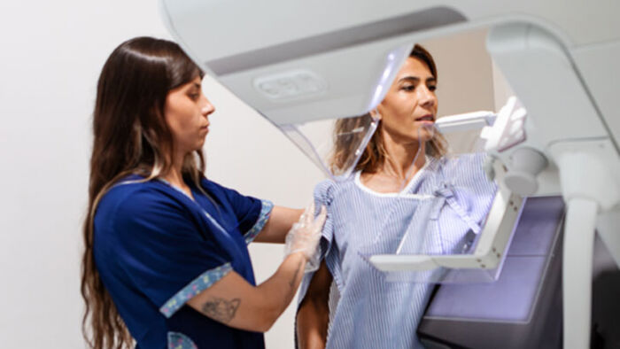 a woman undergoes a mammogram