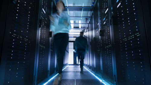 staff walk through a server room at a data centre