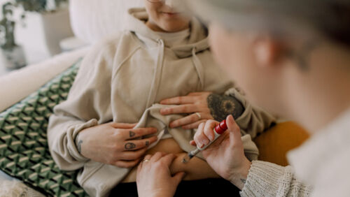 a woman receives an injection as part of ongoing ivf treatment