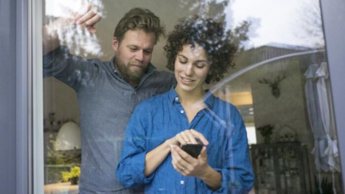 Young family at an open home inspecting windows