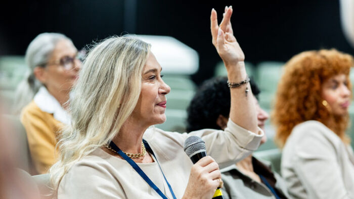 a woman asks a question at a shareholder conference