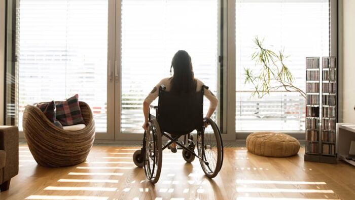 a young woman is pictured in a wheelchair