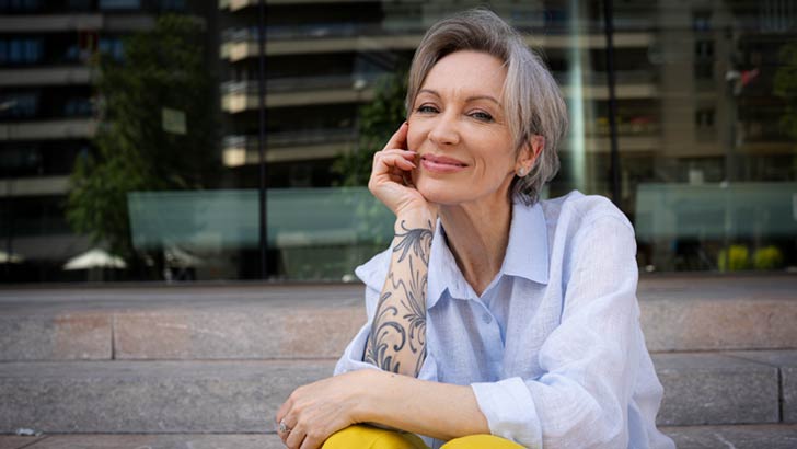 a woman who invests looks down the camera